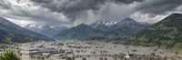Flooded valley under storm clouds