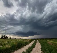 Storm front approaching over farmland