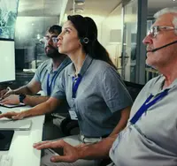 Forecasters at a weather operations desk