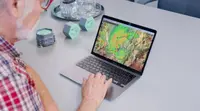 Meratch sensors beside a laptop showing a nowcast map