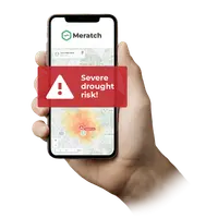 Phone in hand showing a severe drought risk alert