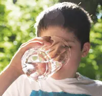 Child drinking a glass of water