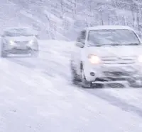 Cars driving through heavy snowfall